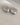 A close-up of a pair of thick, highly polished 18K gold-plated huggie hoop earrings featuring a smooth tapered design and a secure hinged snap closure, isolated on a white background.-9