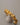 A close-up of a chunky, premium open-cuff bracelet featuring an irregular molten gold and crushed foil texture, made of real gold-plated brass, resting elegantly on a smooth grey background.-4