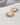 A close-up of a chunky, wavy 18K gold-plated solid copper adjustable ring, featuring flush-set colorful cubic zirconia stones in light blue, dark blue, and clear star shapes, isolated on a white background.-4