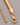 A close-up of a long, thick gold snake chain necklace showing its smooth, fluid flat herringbone texture, featuring a lobster clasp and a 5cm extension chain, resting on a clean grey background.-3
