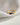 A close-up of a chunky, wavy 18K gold-plated solid copper adjustable ring, featuring flush-set colorful cubic zirconia stones in light blue, dark blue, and clear star shapes, isolated on a white background.-5