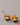 A close-up of a pair of high-gloss, real gold-plated hollow dome earrings featuring 925 sterling silver posts and clear silicone earring backs, resting on a smooth grey background.-3