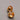 A close-up of a pair of high-gloss, real gold-plated hollow dome earrings featuring 925 sterling silver posts and clear silicone earring backs, resting on a smooth grey background.-2